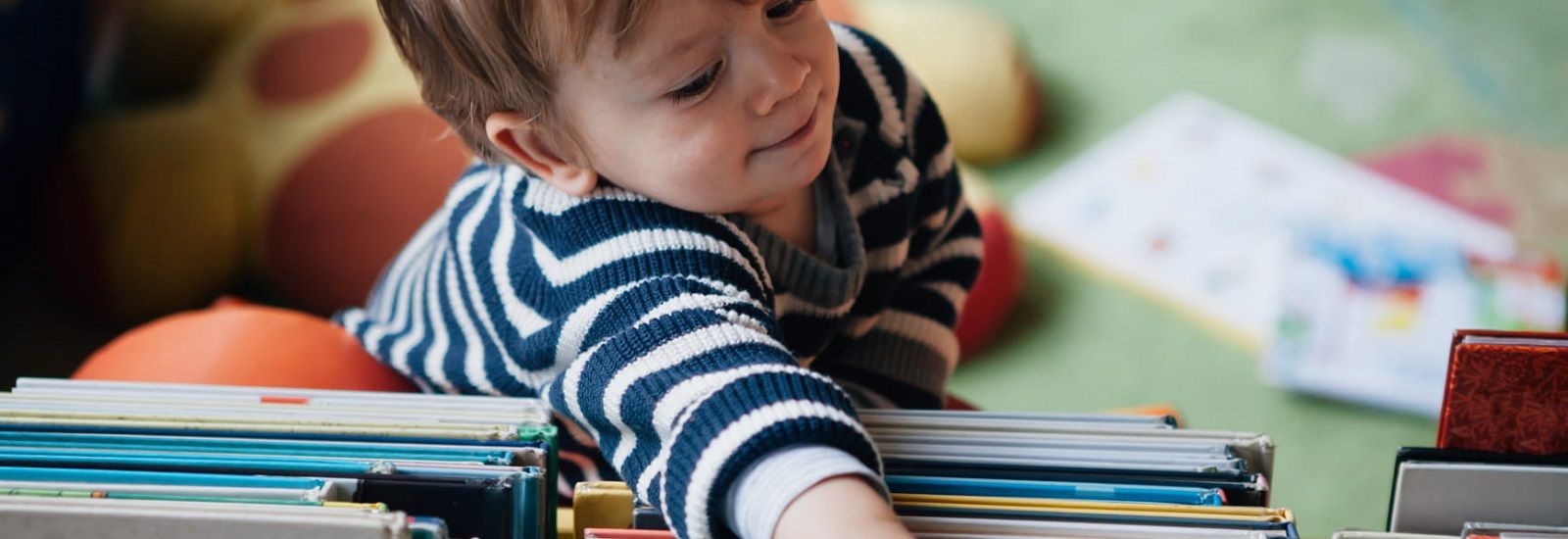 Baby crawling on books banner image