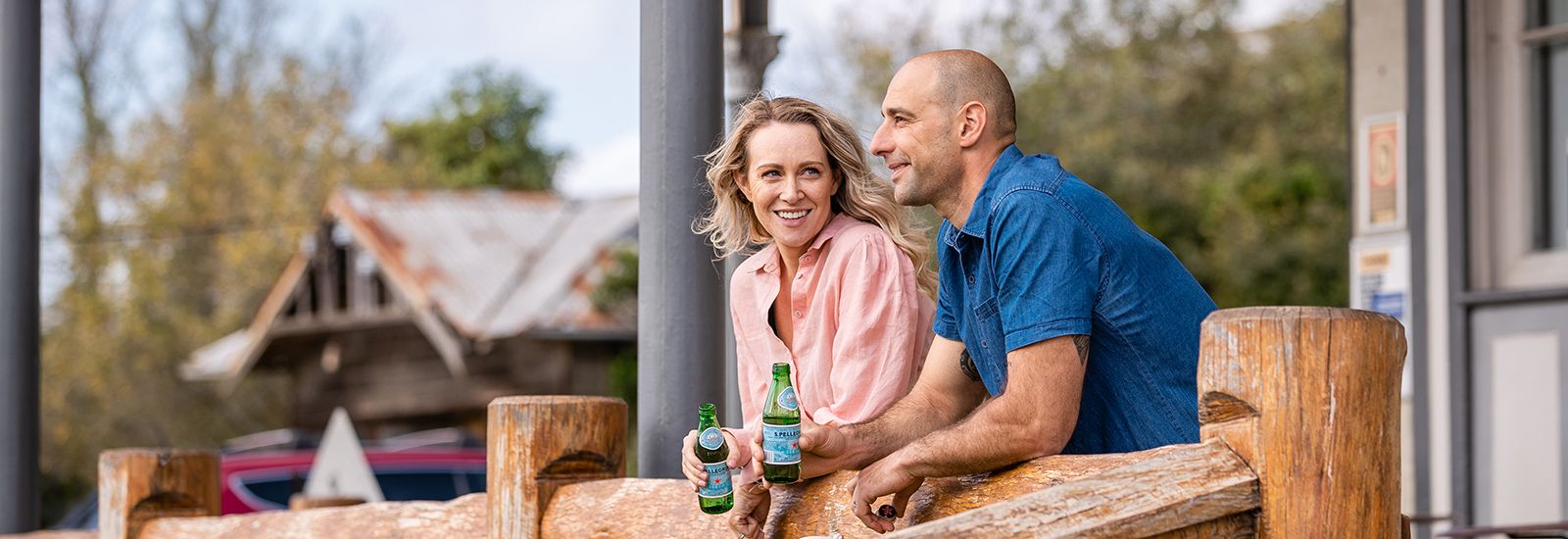 A man and a woman at a rural property having a drink banner image