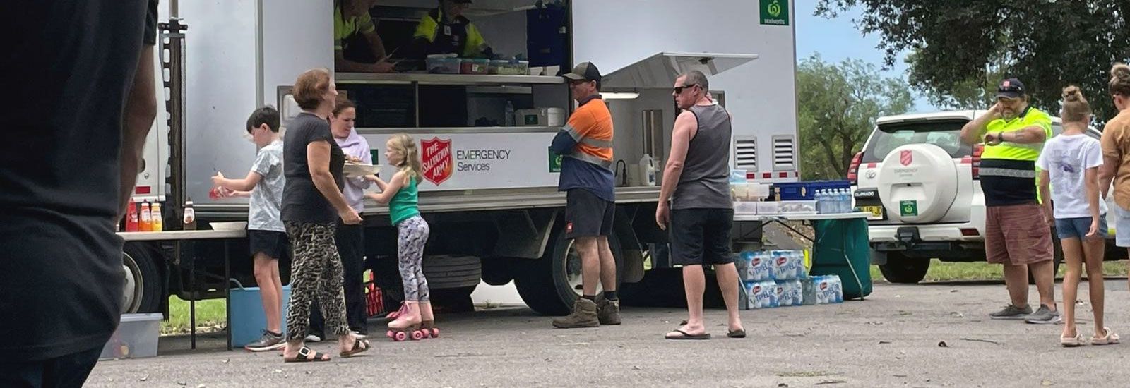 people receiving assistance from a food truck banner image